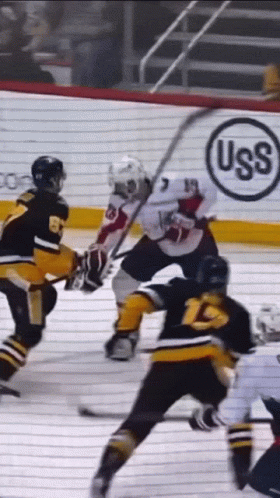 A Hockey Game Is Being Played In Front Of An Uss Advertisement GIF