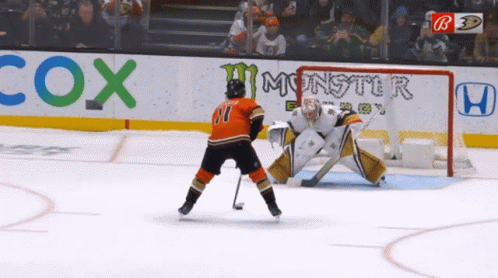 A Hockey Game Is Being Played In Front Of Cox Monster And Honda Ads GIF