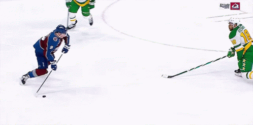 a hockey game is being played on a ice rink