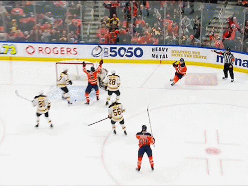 A Hockey Game Is Being Played On A Rink Sponsored By Rogers And Heavy Metal GIF