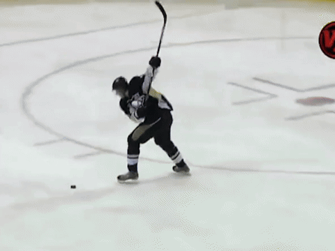 A Hockey Game Is Being Played On A Rink With Lumber Advertisements On The Walls GIF