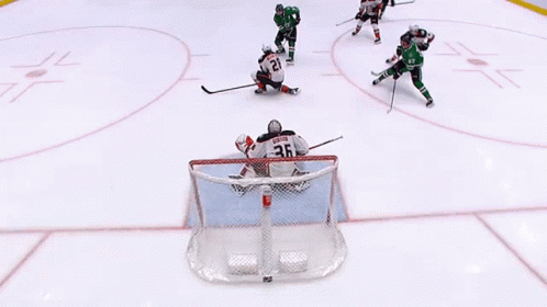A Hockey Game Is Being Played With A Goalie Wearing Number 20 GIF