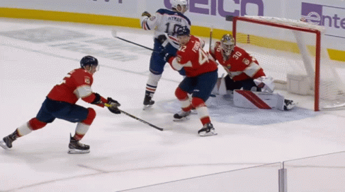 a hockey game is being played with a goalie wearing number 24