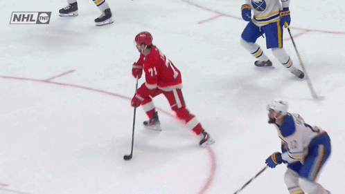 A Hockey Game Is Being Played With A Nhl Logo On The Ice GIF