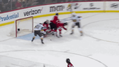 A Hockey Game Is Being Played With Ads For Prudential And Verizon GIF