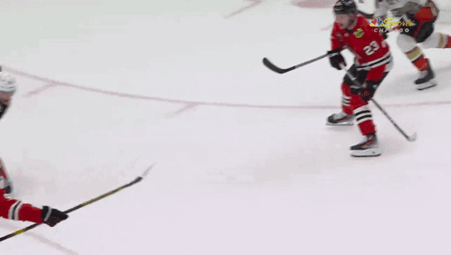 A Hockey Goalie Is Laying On The Ice In Front Of An Advertisement For Endeavor GIF
