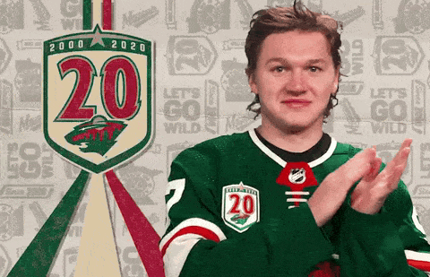 A Hockey Player Applauds In Front Of A Sign That Says 20 On It GIF