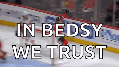 A Hockey Player Celebrates A Goal With The Words In Bedsy We Trust Below Him GIF
