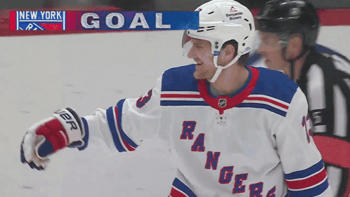 A Hockey Player For The New York Rangers Is Standing In Front Of A Scoreboard GIF