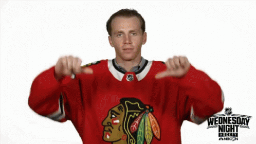 A Hockey Player Giving A Thumbs Down Sign In Front Of A Sign That Says Wednesday Night GIF