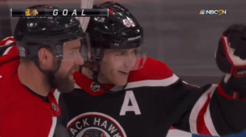 A Hockey Player In A Black And Red Jersey With The Letter A On It GIF