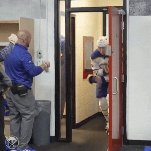 A Hockey Player In A Blue Jersey With The Number 10 GIF