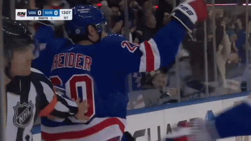 A Hockey Player In A Blue Jersey With The Number 20 On The Back GIF