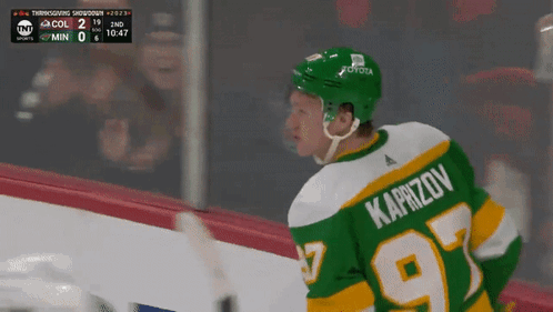 A Hockey Player In A Green Jersey With The Number 97 On It GIF