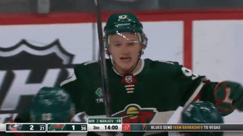 A Hockey Player In A Green Jersey With The Number 97 On The Back GIF
