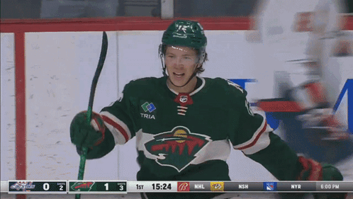 A Hockey Player In A Green Jersey With Tria On The Sleeve GIF
