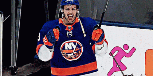 A Hockey Player In A New York Islanders Jersey Is Holding A Hockey Stick GIF