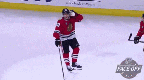 A Hockey Player In A Red Jersey With The Number 38 On It GIF