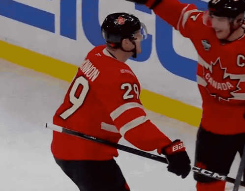 A Hockey Player In A Red Jersey With The Number 9 On It GIF