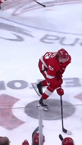A Hockey Player In A Red Uniform With The Number 52 On His Back GIF