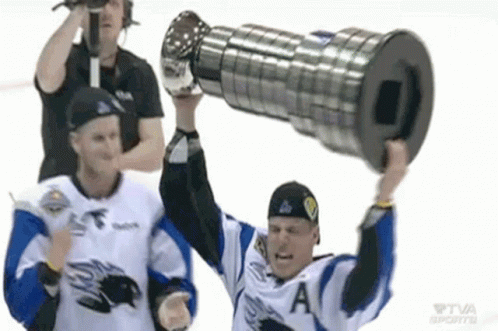 A Hockey Player Is Holding Up A Trophy While Another Player Watches . GIF