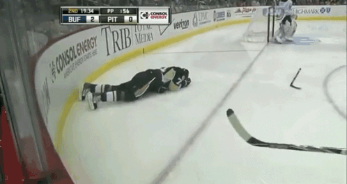 A Hockey Player Is Laying On The Ice In Front Of A Banner That Says Consox Energy GIF