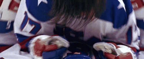 A Hockey Player Is Laying On The Ice With The Number 17 On His Jersey GIF
