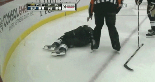 a hockey player is laying on the ice with the scoreboard showing 2nd 19:33 buff 2 pit