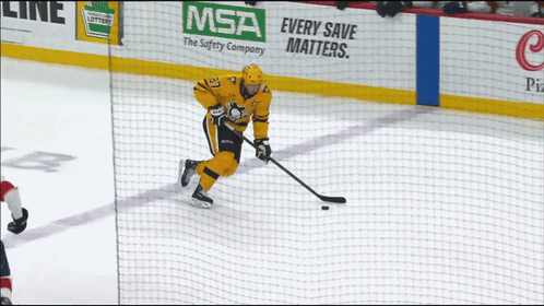 A Hockey Player Is On The Ice With A Msa Advertisement Behind Him GIF