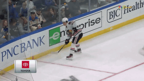 A Hockey Player Is Skating On The Ice In Front Of A Pnc Bank Banner GIF