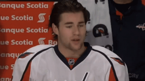 A Hockey Player Is Standing In Front Of A Banner That Says Banque Scotia GIF