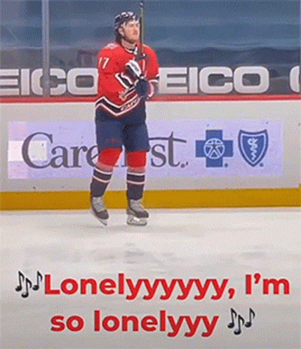 A Hockey Player Is Standing On The Ice In Front Of A Sign For Eico GIF