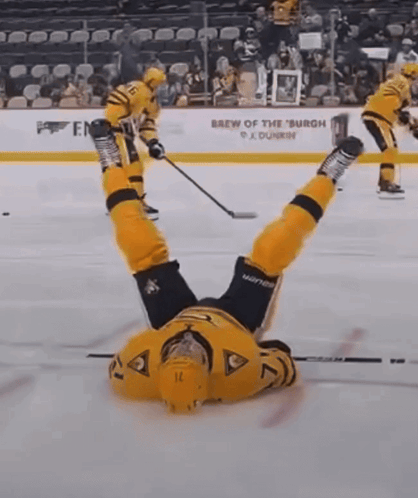 a hockey player is upside down on the ice in front of the brew of the burgh sign