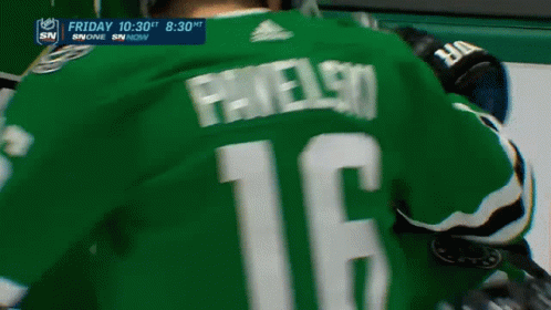 A Hockey Player Is Wearing A Green Jersey With The Number 12 On The Back GIF