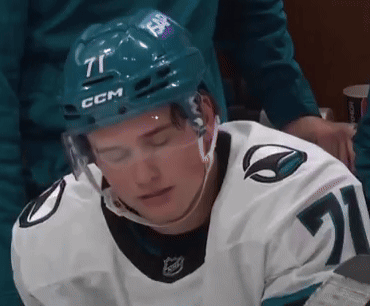 A Hockey Player Is Wearing A Helmet With The Number 71 On It GIF
