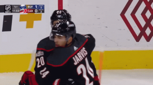 A Hockey Player Named Jarvis Is Hugging Another Hockey Player GIF