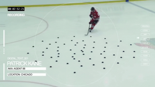 A Hockey Player Named Patrick Kane Is Standing On The Ice GIF