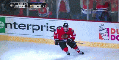 A Hockey Player On The Ice With A Dunkin Donuts Ad In The Background GIF