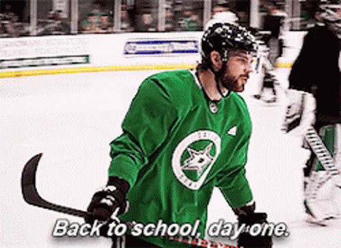 A Hockey Player Says Back To School Day One While Holding A Hockey Stick GIF