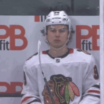 A Hockey Player Stands In Front Of A Cb Fit Sign GIF