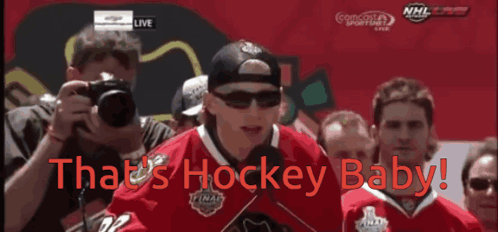 A Hockey Player Stands In Front Of A Crowd With The Words That 'S Hockey Baby On The Bottom GIF