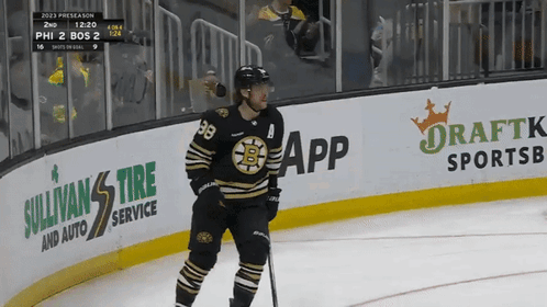 A Hockey Player Stands On The Ice In Front Of A Banner For Sullivan 'S Tire Service GIF