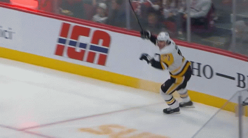 A Hockey Player Stands On The Ice In Front Of A Banner That Says " Ica " GIF