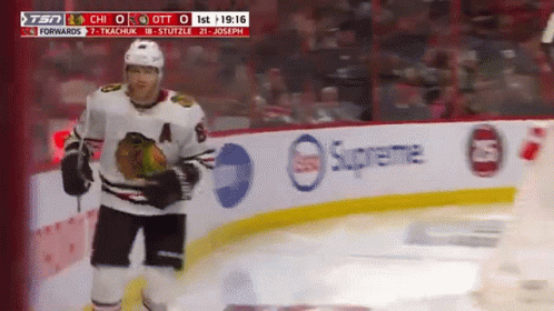A Hockey Player Stands On The Ice In Front Of A Supreme Banner GIF
