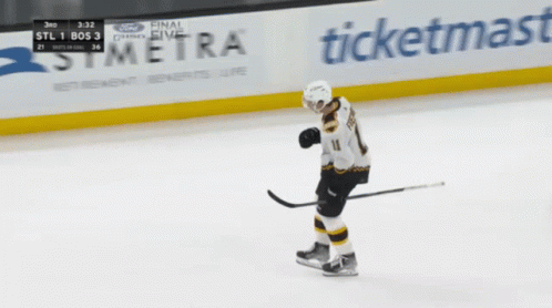 A Hockey Player Stands On The Ice In Front Of A Symera Sign GIF