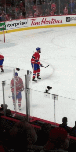 A Hockey Player Stands On The Ice In Front Of A Tim Hortons Advertisement GIF