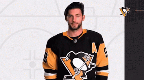 A Hockey Player Wearing A Black And Yellow Jersey With The Number 8 On It GIF