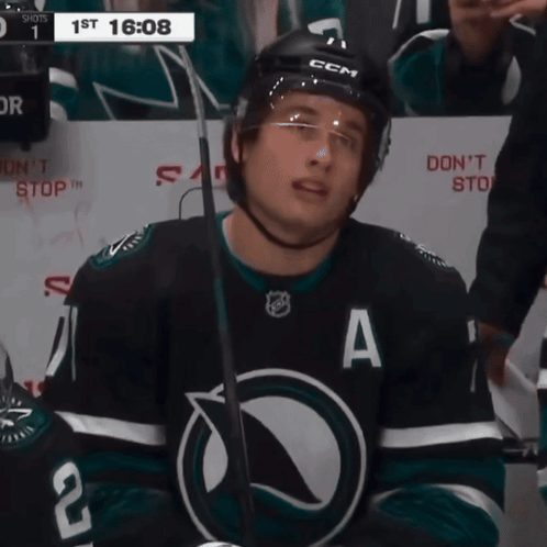 A Hockey Player Wearing A Black Jersey With The Letter A On It GIF