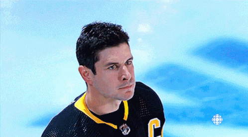 A Hockey Player Wearing A Black Jersey With The Letter C On It GIF