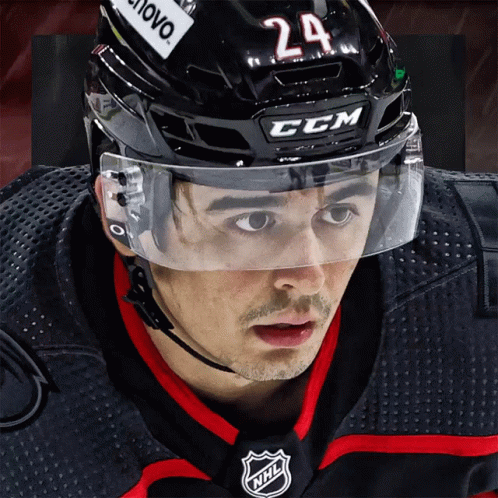 A Hockey Player Wearing A Ccm Helmet With The Number 24 On It GIF